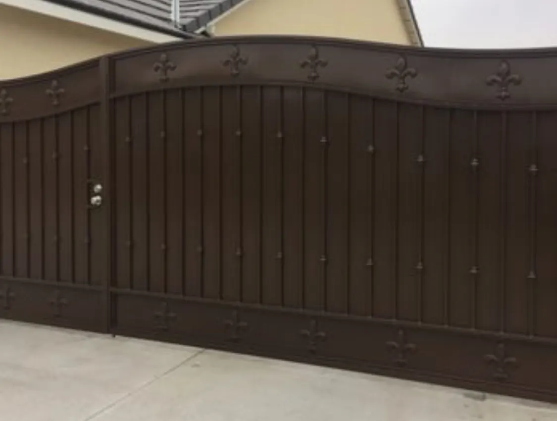 Full privacy double driveway gate with fleur de lis detail by SG Fabrication