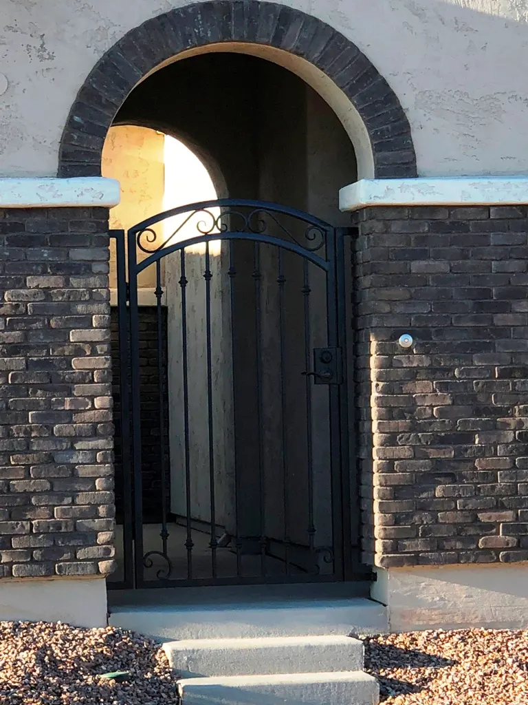 Steel entry gate with custom scrollwork by SG Fabrication